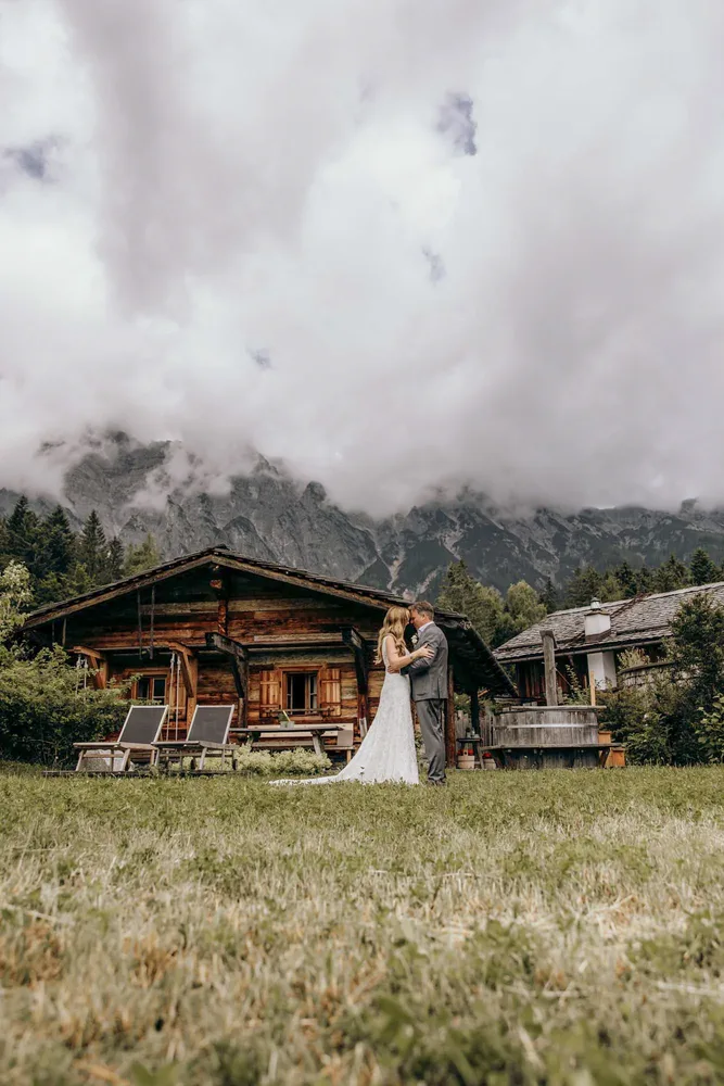 Chaletdorf in den österreichischen Alpen mit Nebel und Bergen für ein Elopement